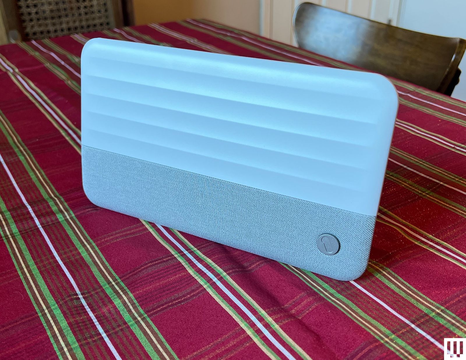 One For All Suburbs Ultimate  antenna a white rectangular device sitting on a striped tablecloth