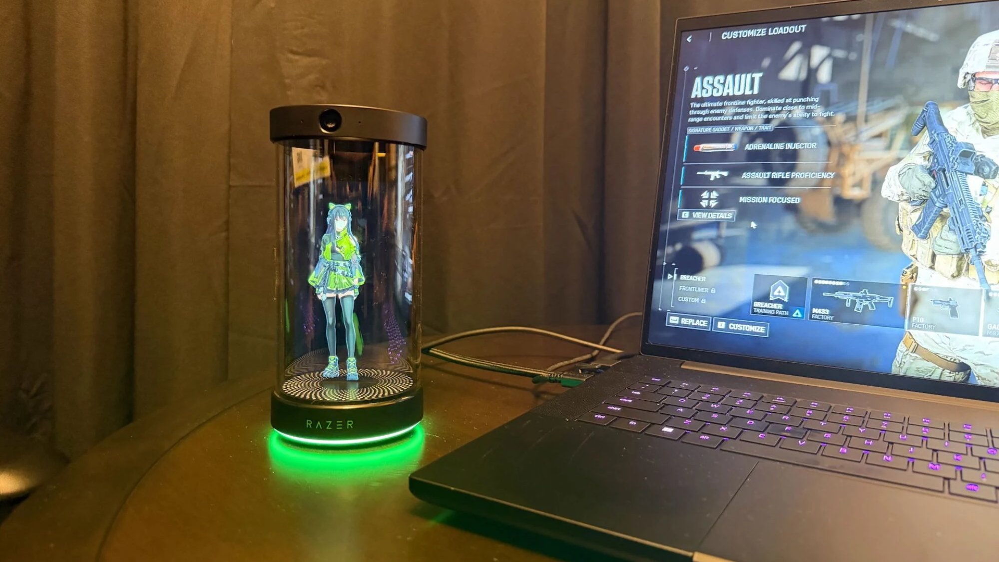 A zoomed out photo of Kira inside the holodeck alongside a laptop playing Battlefield 6