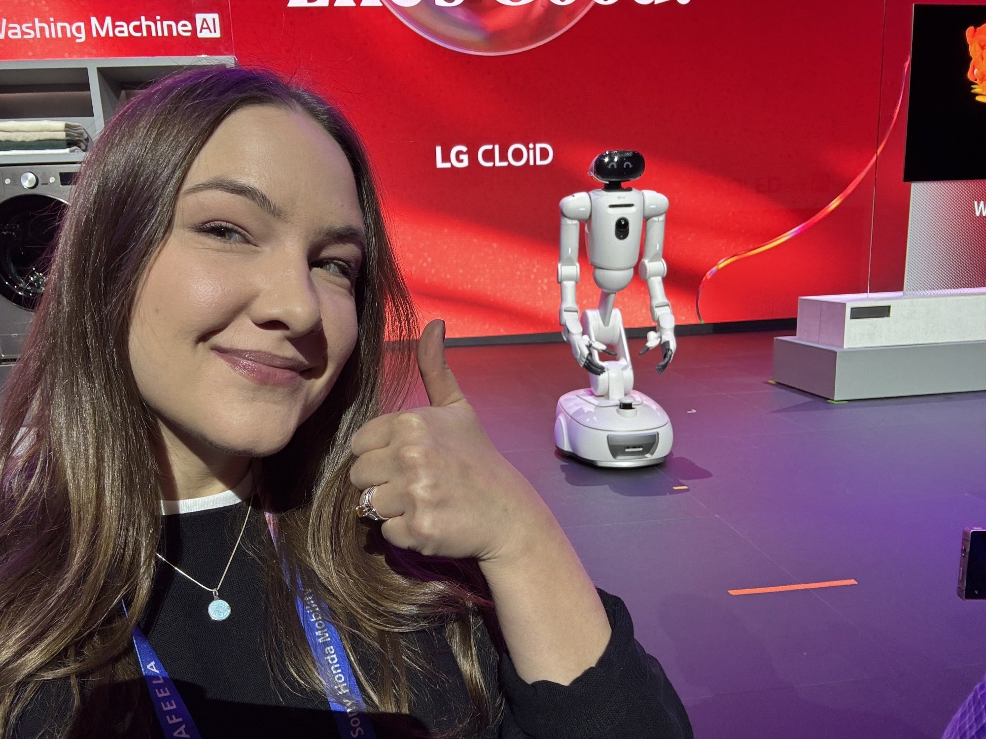 young woman posing alongside LG's CLOiD humanoid robot